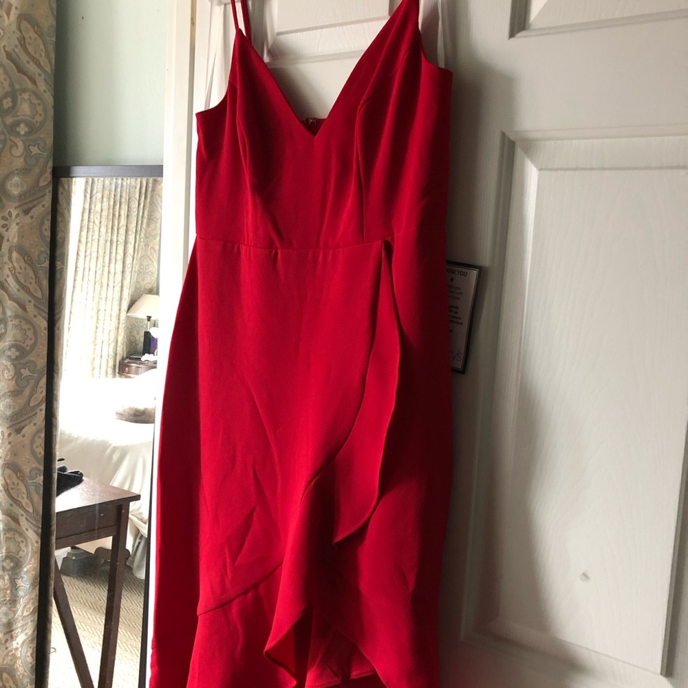 Hot red sleeveless dress with diagonal flirty hem.